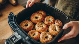 Cottage cheese bagels cooking in an air fryer basket