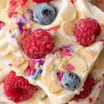 Frozen yogurt bark with sprinkles and berries
