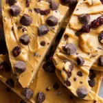 Vegan protein cookie dough bark with sprinkles on wooden board