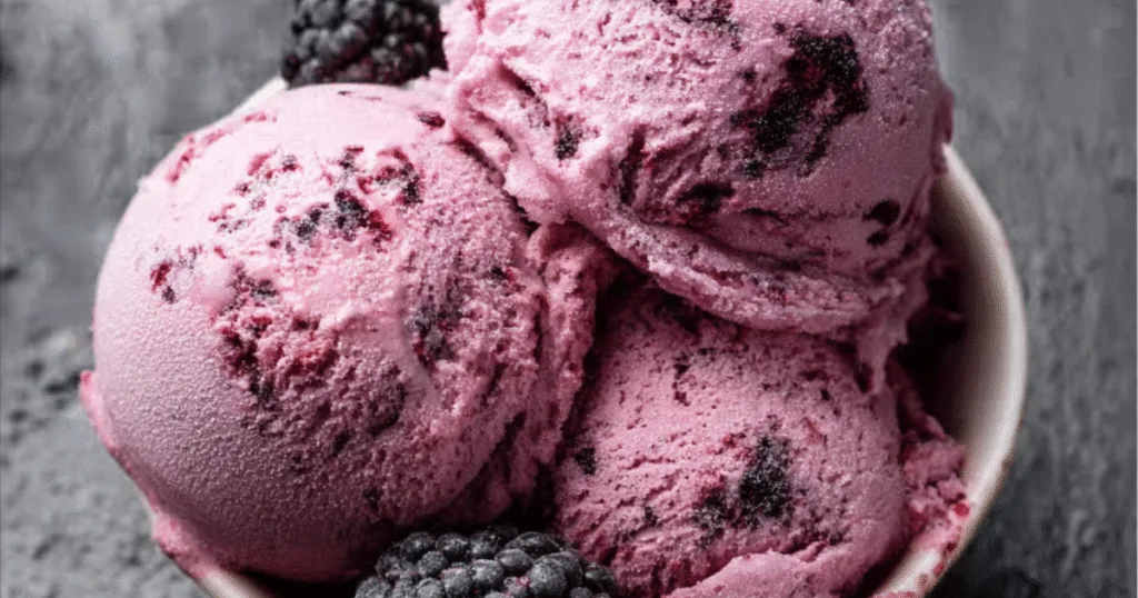 Bowl of black raspberry ice cream with fresh blackberries