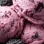 Bowl of black raspberry ice cream with fresh blackberries