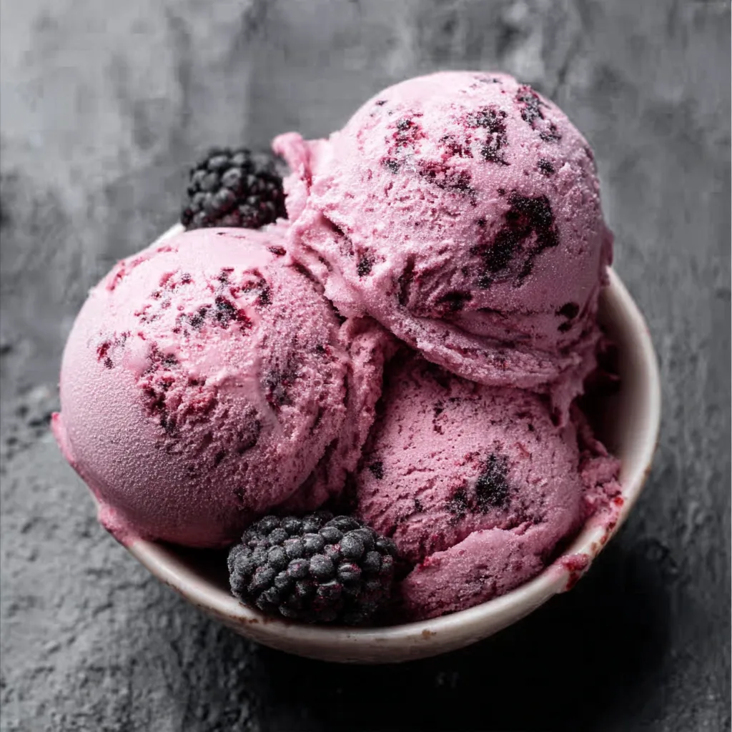 Bowl of black raspberry ice cream with fresh blackberries