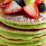 Vegan matcha pancakes with strawberries, kiwi, and blueberries